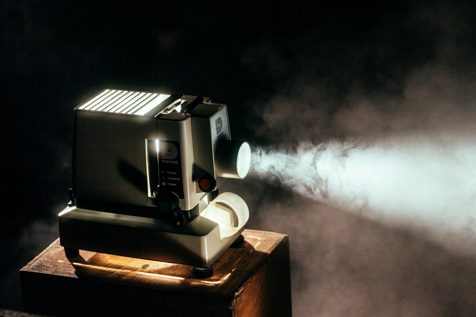 Film projector casting light through mist